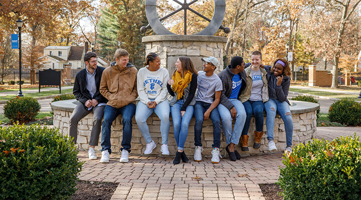 students hanging out by helm monument